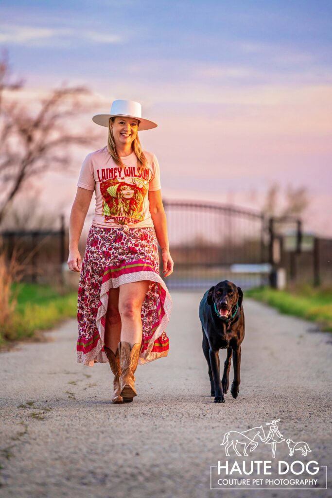 Woman walking along a path in North Dallas with her black lab.