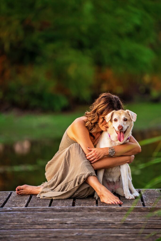 Woman wraps her arms around her dog lovingly
