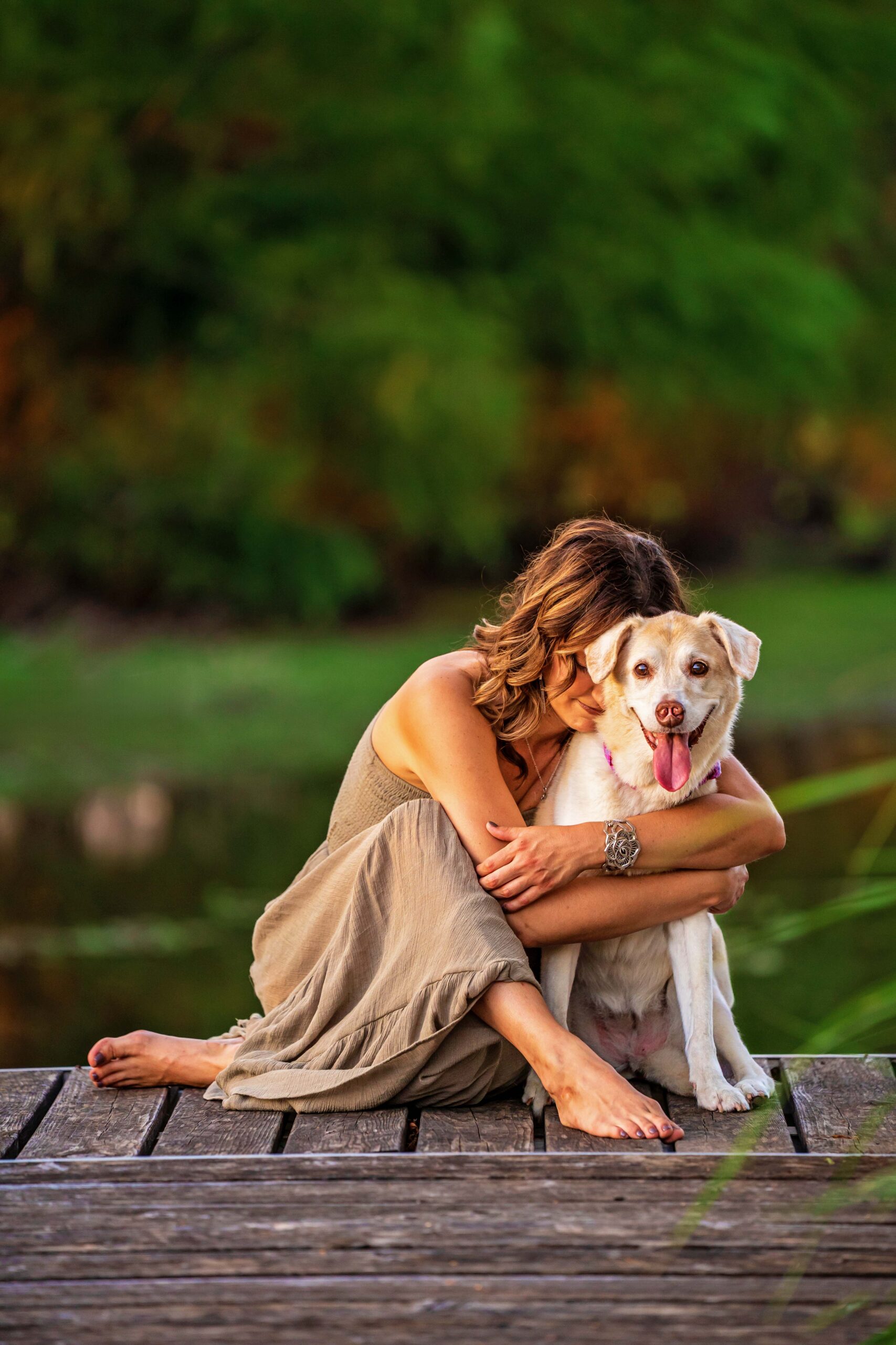 Woman wraps her arms around her dog lovingly