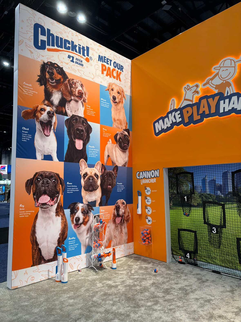 Large standing display at Petmate Chuckit booth at Global Pet Expo featuring photos taken by Haute Dog Pet Photography.
