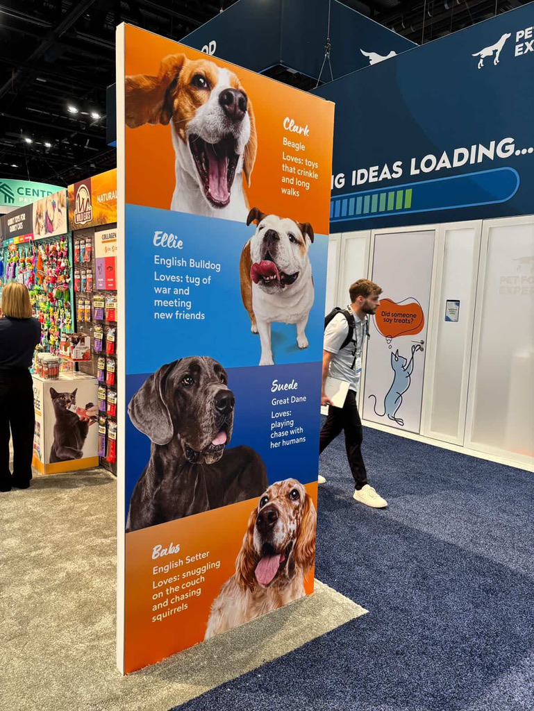 Standing display at Petmate Chuckit booth at Global Pet Expo featuring photos taken by Haute Dog Pet Photography.