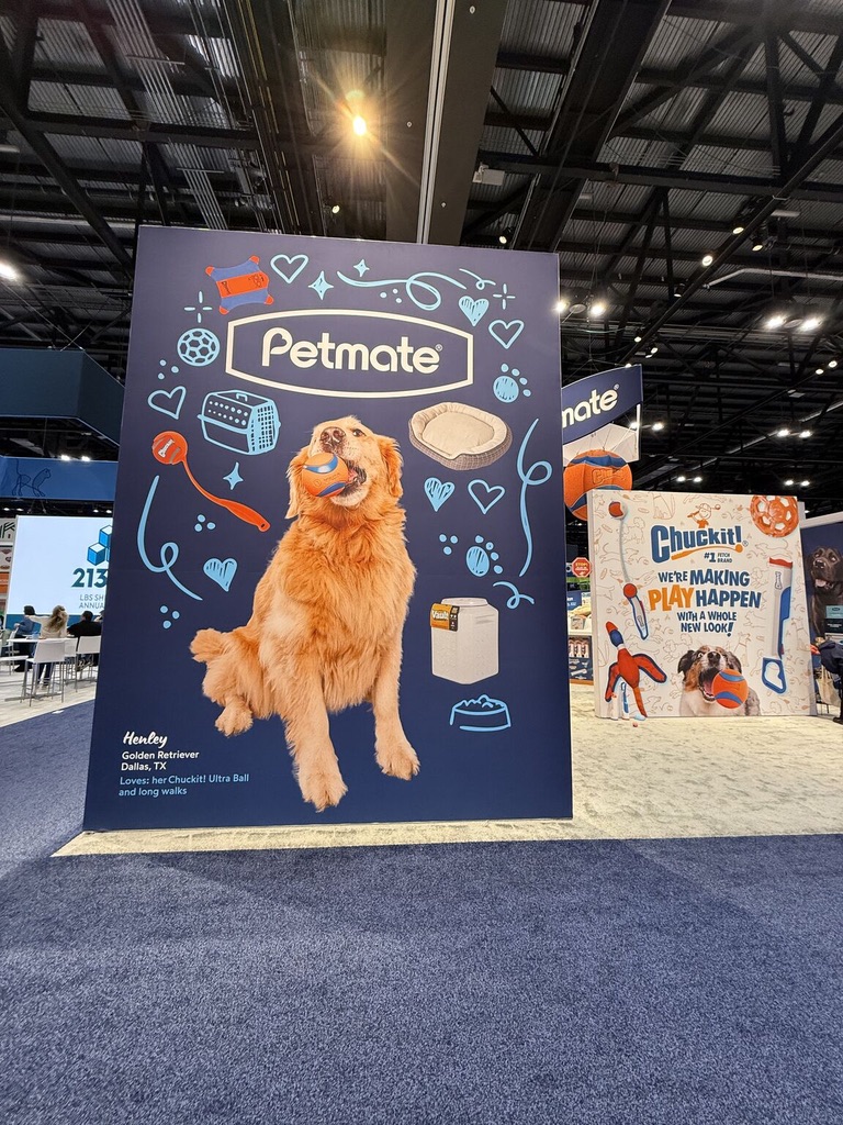 Large wall display at the Petmate Chuckit booth at Global Pet Expo featuring photos taken by Haute Dog Pet Photography.